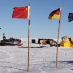 A group of people sitting in the snow.