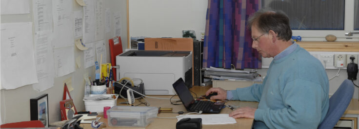 UK Arctic Station Leader Nick Cox in the office at Ny-Ålesund