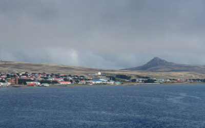 A large body of water with a mountain in the background.