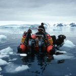 A group of people riding skis on a body of water.