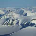 A close up of a snow covered mountain.