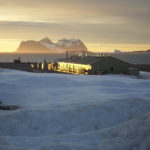 A sandy beach covered in snow.