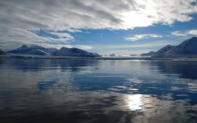 A body of water with a mountain in the background.