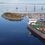 A boat is docked next to a body of water