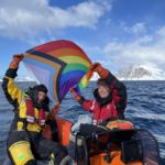 A group of people riding on the back of a boat