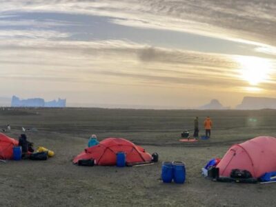 A group of people lying in a tent