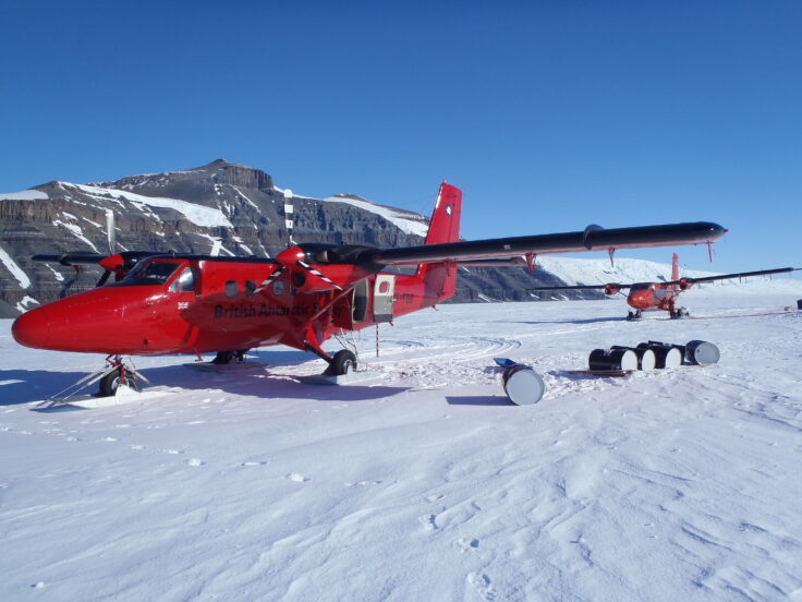 A group of people riding skis on top of a snow covered slope