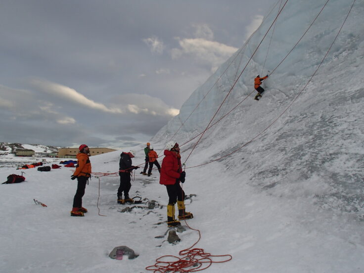 A group of people riding skis on top of a snow covered slope