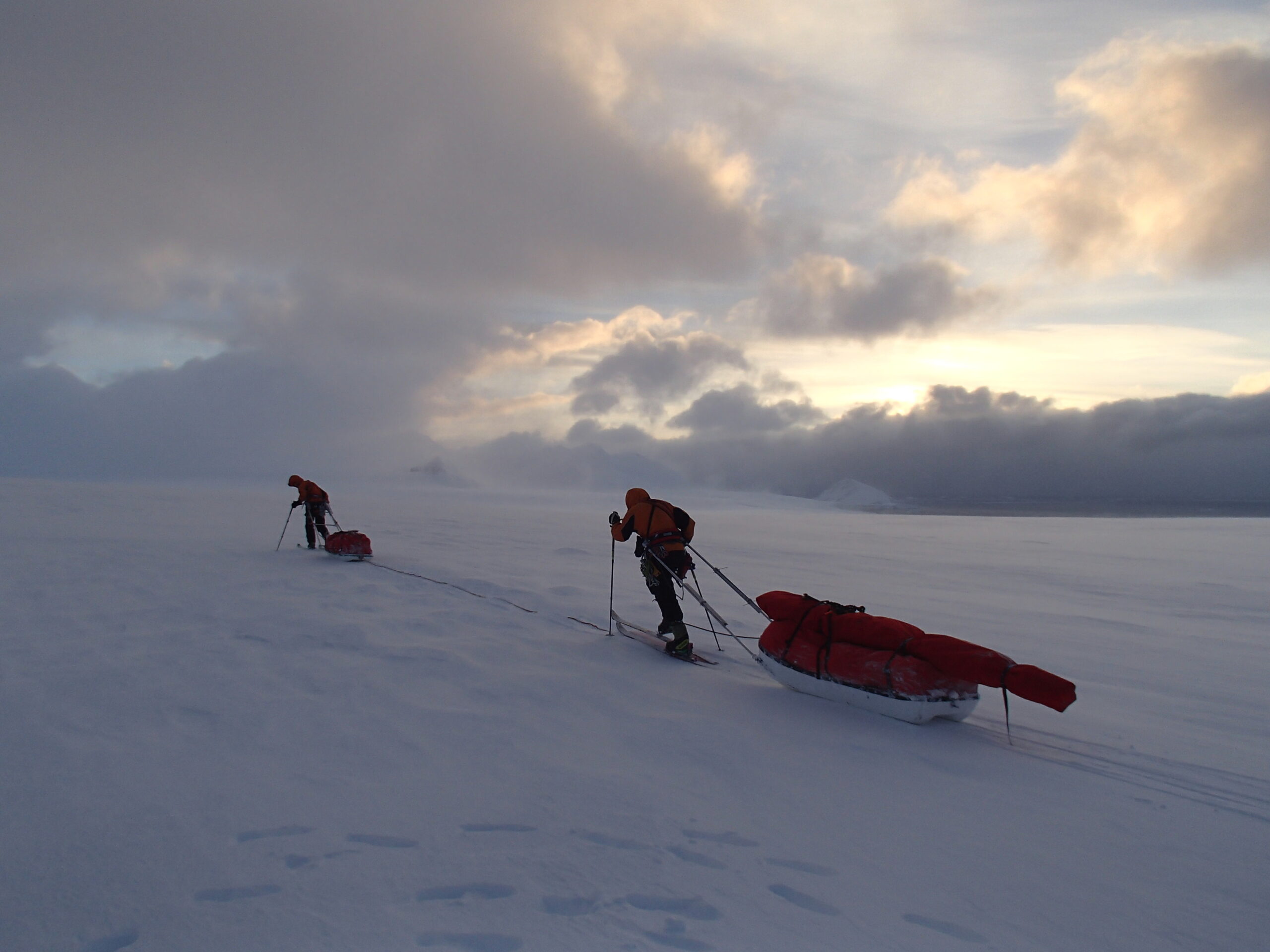 A group of people riding skis down a snow covered slope