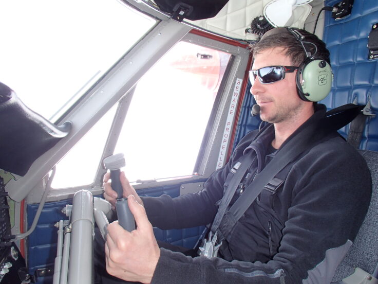 A man wearing sunglasses and holding a gun