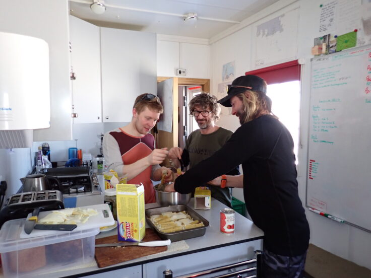 A man standing in a kitchen preparing food
