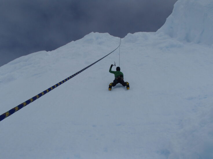 A man riding skis down a snow covered slope