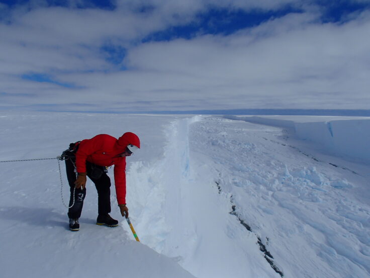 A man is cross country skiing in the snow