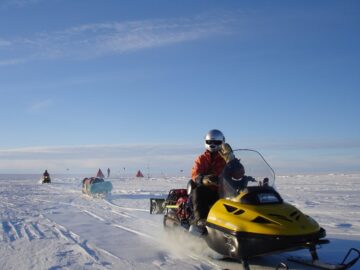 A group of people riding skis on a snowy hill