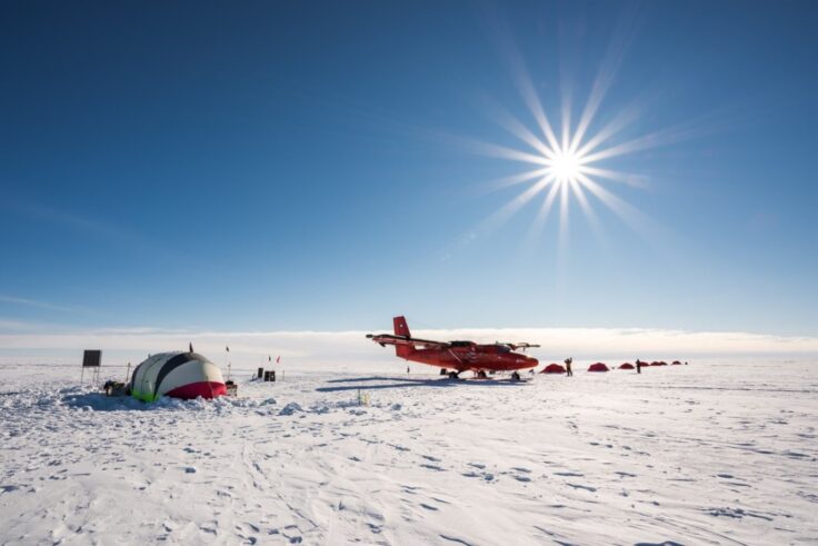 A group of people sitting in the snow