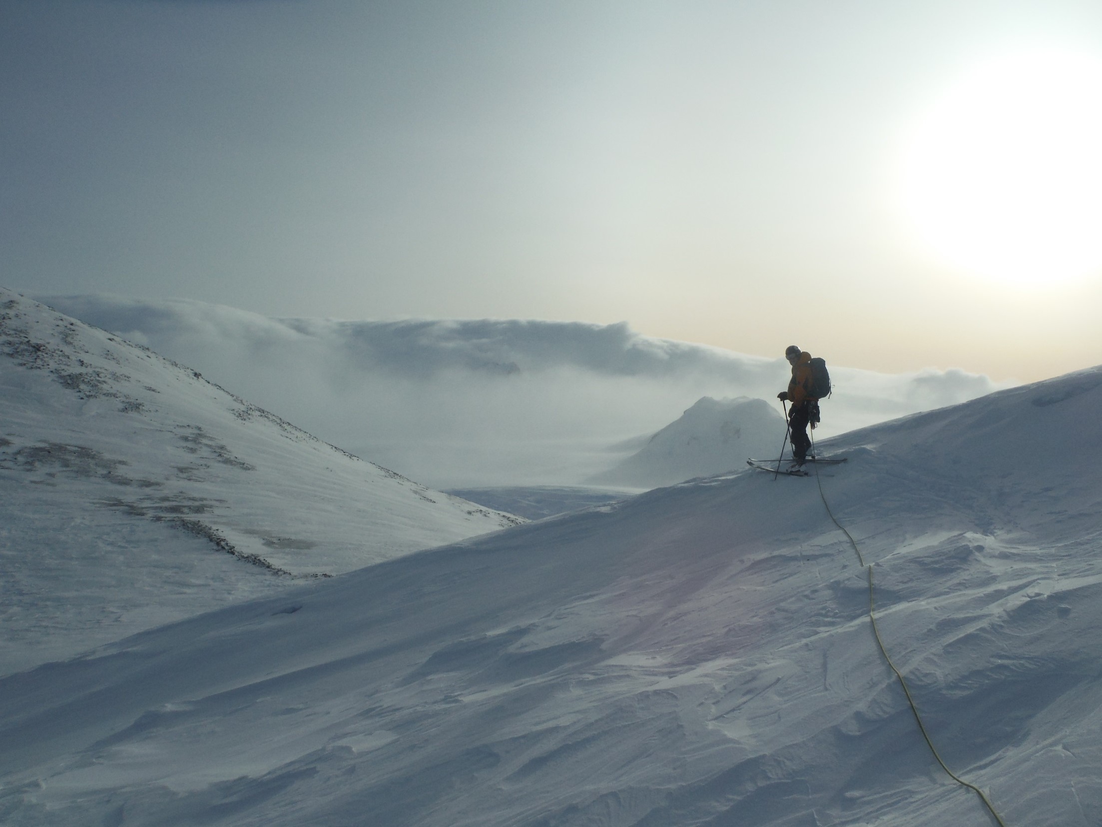 A man riding skis down a snow covered mountain