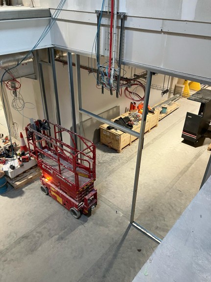 The inside of a very large room with a trolley